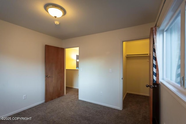 19404 Middleton Loop, Eagle River, AK 99577 - unfurnished bedroom featuring a spacious closet, carpet floors, a closet, and baseboards