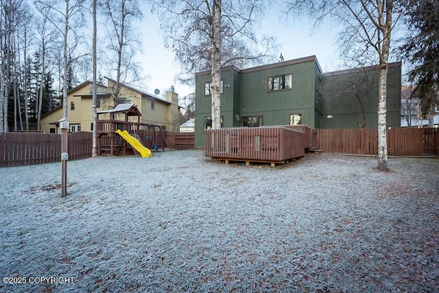 19404 Middleton Loop, Eagle River, AK 99577 - back of house featuring a playground, a fenced backyard, and a deck