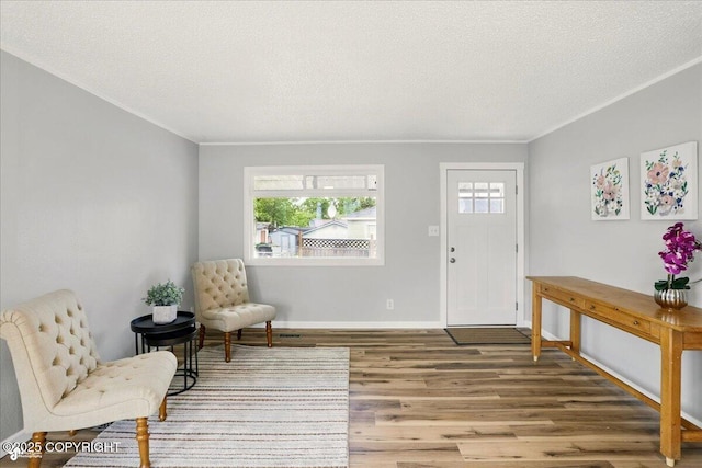3624 E 16th Ave, Anchorage, AK 99508 - entrance foyer featuring wood finished floors, plenty of natural light, a textured ceiling, and baseboards
