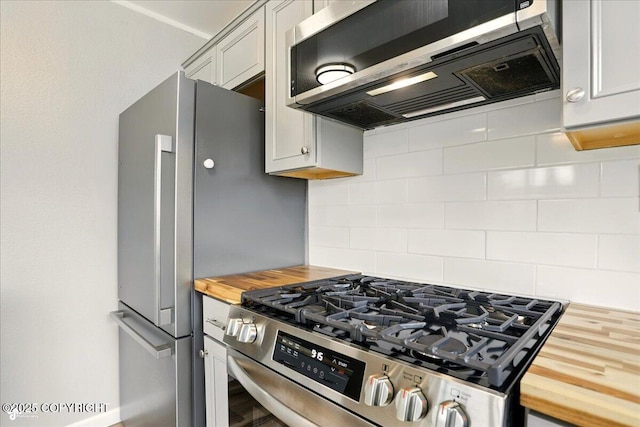 3624 E 16th Ave, Anchorage, AK 99508 - kitchen with wooden counters, appliances with stainless steel finishes, decorative backsplash, and extractor fan