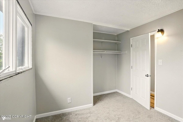 3624 E 16th Ave, Anchorage, AK 99508 - unfurnished bedroom with carpet, a closet, a textured ceiling, and baseboards