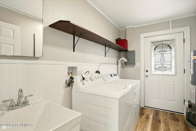 3624 E 16th Ave, Anchorage, AK 99508 - laundry area featuring wood finished floors, washing machine and clothes dryer, ornamental molding, electric panel, and a wainscoted wall