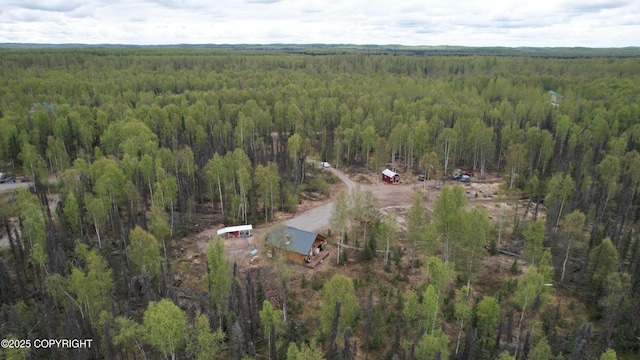 view of property location with a heavily wooded area