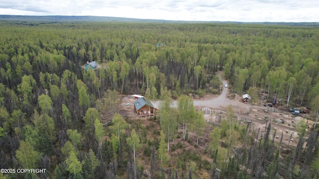 aerial view of property's location featuring a forest