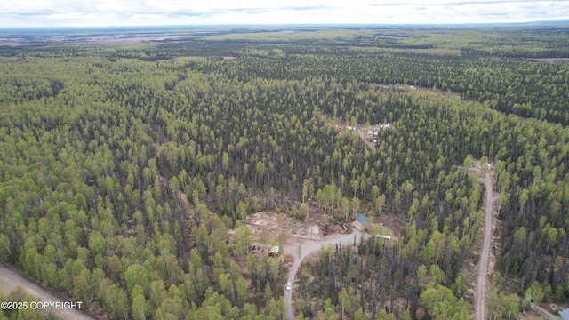 view of property location with a heavily wooded area