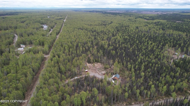 view of property location featuring a forest