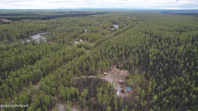 view of property location featuring a heavily wooded area