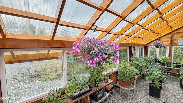 sunroom / solarium featuring vaulted ceiling