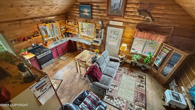 living room featuring rustic walls, hardwood / wood-style flooring, lofted ceiling, and wooden ceiling