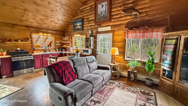 living area featuring light wood-type flooring, wood ceiling, wood walls, and high vaulted ceiling