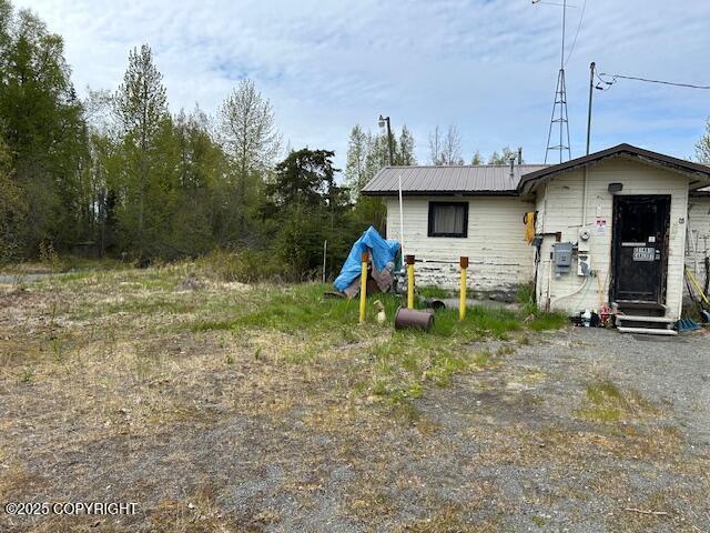 31481 Carl St, Soldotna, AK 99669 - view of front facade with metal roof and entry steps