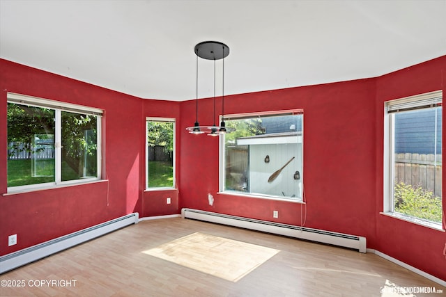 10321 Compass Cir, Anchorage, AK 99515 - unfurnished room featuring a baseboard heating unit, wood finished floors, and healthy amount of natural light