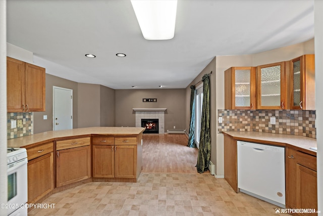 10321 Compass Cir, Anchorage, AK 99515 - kitchen with white appliances, a peninsula, light countertops, backsplash, and glass insert cabinets