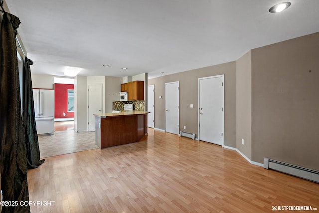10321 Compass Cir, Anchorage, AK 99515 - unfurnished living room featuring a baseboard radiator, light wood finished floors, baseboards, a baseboard heating unit, and recessed lighting