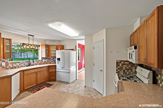10321 Compass Cir, Anchorage, AK 99515 - kitchen featuring white appliances, a sink, backsplash, and brown cabinetry
