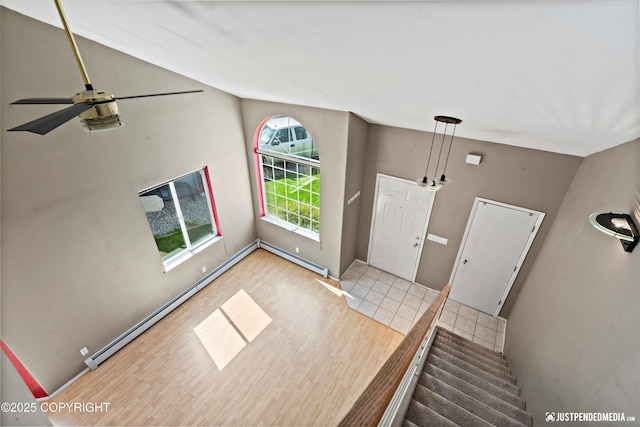 10321 Compass Cir, Anchorage, AK 99515 - entryway with a baseboard heating unit, a baseboard radiator, wood finished floors, lofted ceiling, and ceiling fan