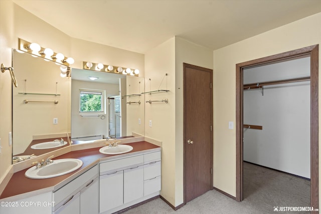 10321 Compass Cir, Anchorage, AK 99515 - full bathroom with double vanity, a shower, a closet, and baseboards