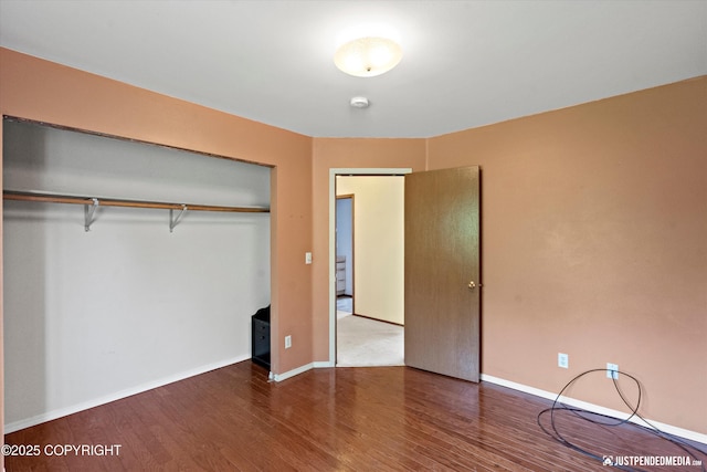 10321 Compass Cir, Anchorage, AK 99515 - unfurnished bedroom with wood finished floors, a closet, and baseboards