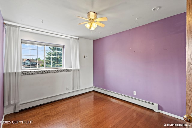 10321 Compass Cir, Anchorage, AK 99515 - empty room featuring a ceiling fan, baseboard heating, and wood finished floors