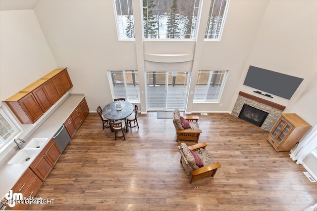 53578 Bell Ave, Nikiski/North Kenai, AK 99611 - living area with a high ceiling, a fireplace, wood finished floors, and baseboards