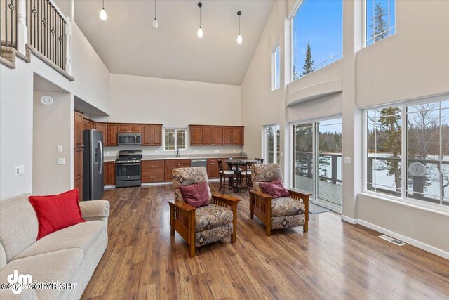 53578 Bell Ave, Nikiski/North Kenai, AK 99611 - living area with high vaulted ceiling, dark wood-type flooring, and baseboards