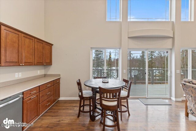 53578 Bell Ave, Nikiski/North Kenai, AK 99611 - dining room with a towering ceiling, dark wood finished floors, and baseboards