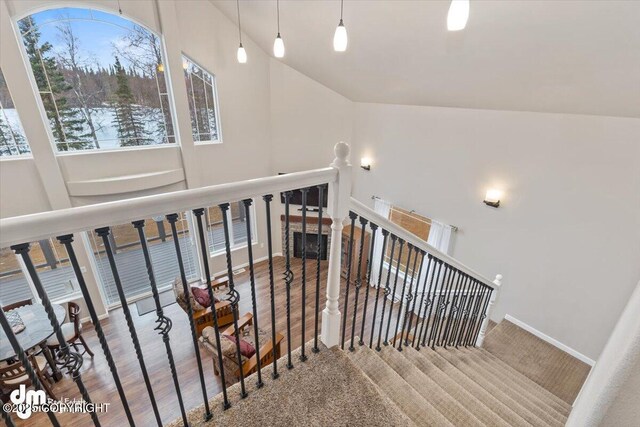 53578 Bell Ave, Nikiski/North Kenai, AK 99611 - stairway featuring wood finished floors, high vaulted ceiling, and baseboards