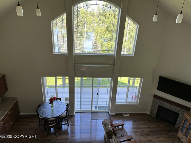 53578 Bell Ave, Nikiski/North Kenai, AK 99611 - doorway to outside with a towering ceiling, baseboards, healthy amount of natural light, and wood finished floors