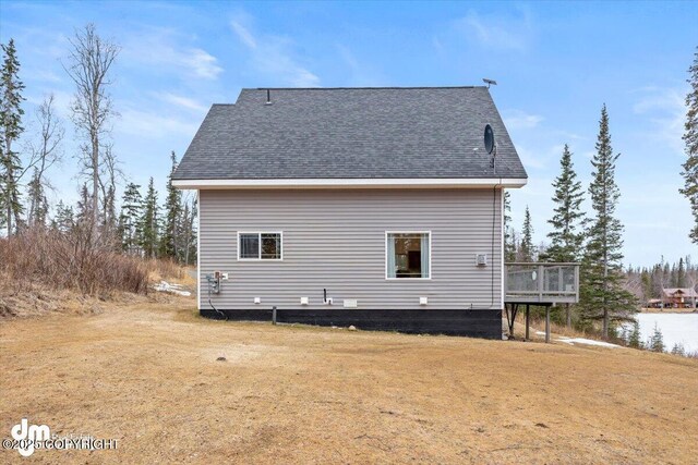 53578 Bell Ave, Nikiski/North Kenai, AK 99611 - view of home's exterior with a wooden deck, a lawn, and a shingled roof
