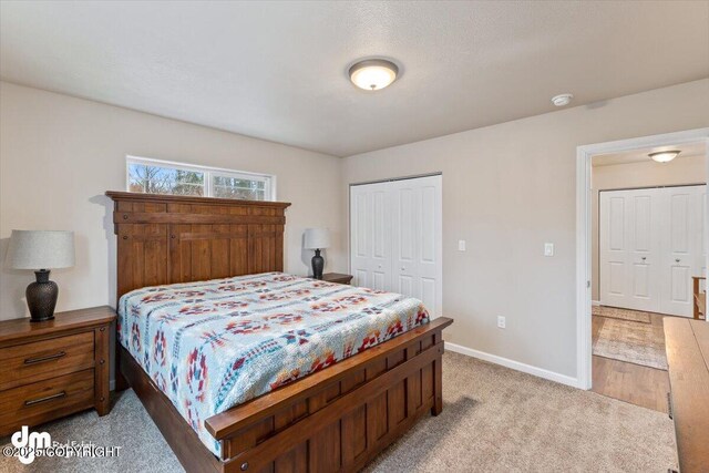53578 Bell Ave, Nikiski/North Kenai, AK 99611 - bedroom featuring a closet, baseboards, and light carpet