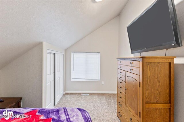 53578 Bell Ave, Nikiski/North Kenai, AK 99611 - bedroom featuring vaulted ceiling, light colored carpet, baseboards, and a closet