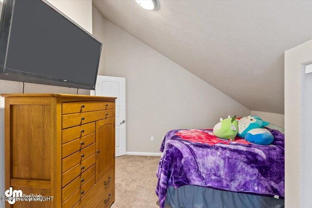 53578 Bell Ave, Nikiski/North Kenai, AK 99611 - bedroom with vaulted ceiling, carpet, and baseboards