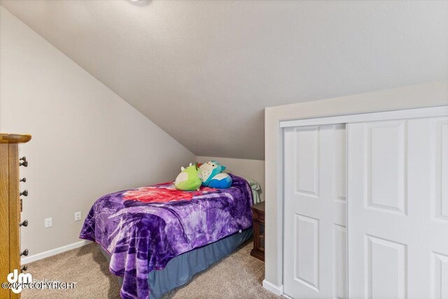 53578 Bell Ave, Nikiski/North Kenai, AK 99611 - carpeted bedroom with lofted ceiling and baseboards