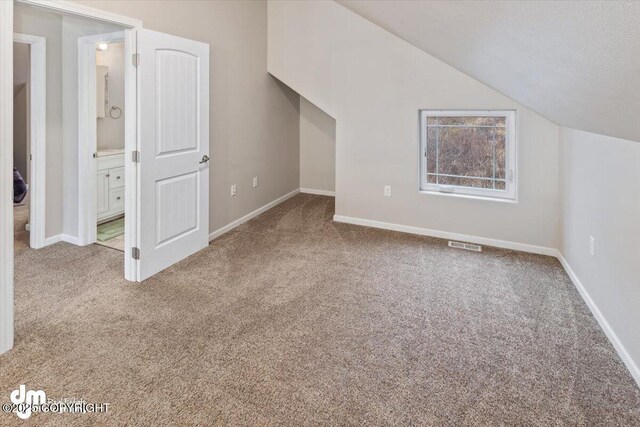 53578 Bell Ave, Nikiski/North Kenai, AK 99611 - additional living space with carpet floors, lofted ceiling, and baseboards