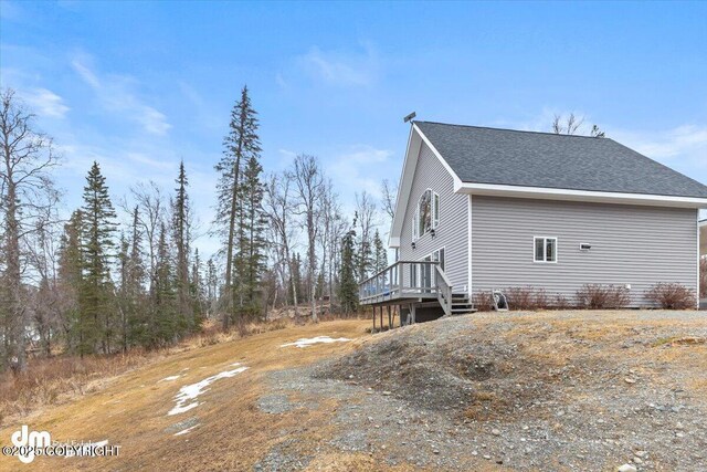 53578 Bell Ave, Nikiski/North Kenai, AK 99611 - view of property exterior with a wooden deck and roof with shingles