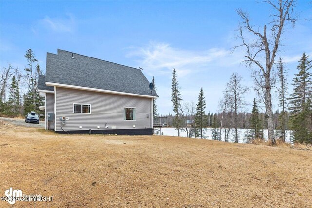 53578 Bell Ave, Nikiski/North Kenai, AK 99611 - view of property exterior featuring a water view, a yard, and a shingled roof