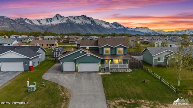 241 N Pasture Pl, Palmer, AK 99645 - traditional-style house featuring a residential view, a mountain view, an attached garage, a porch, and asphalt driveway