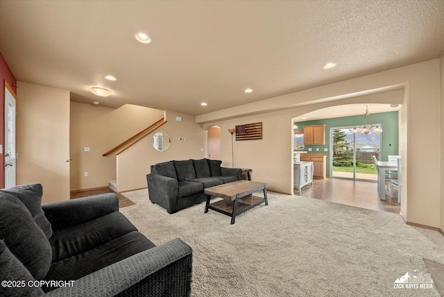 241 N Pasture Pl, Palmer, AK 99645 - living area featuring arched walkways, light carpet, a chandelier, stairway, and recessed lighting