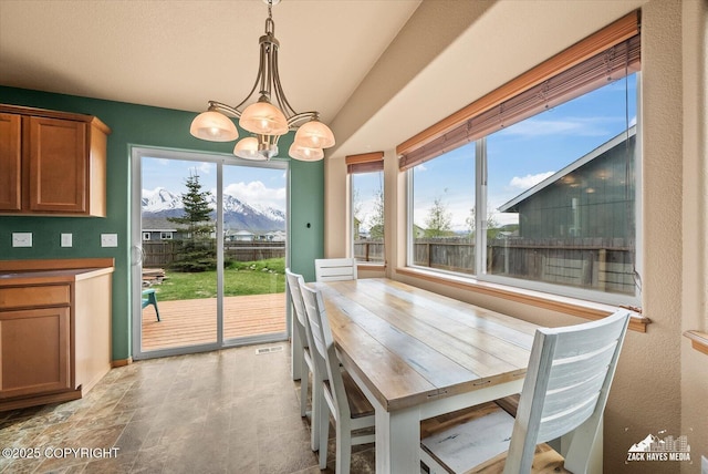 241 N Pasture Pl, Palmer, AK 99645 - dining area with a chandelier, baseboards, and lofted ceiling