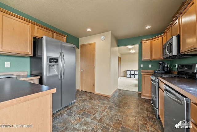 241 N Pasture Pl, Palmer, AK 99645 - kitchen with appliances with stainless steel finishes, dark countertops, baseboards, dark stone finish floors, and recessed lighting