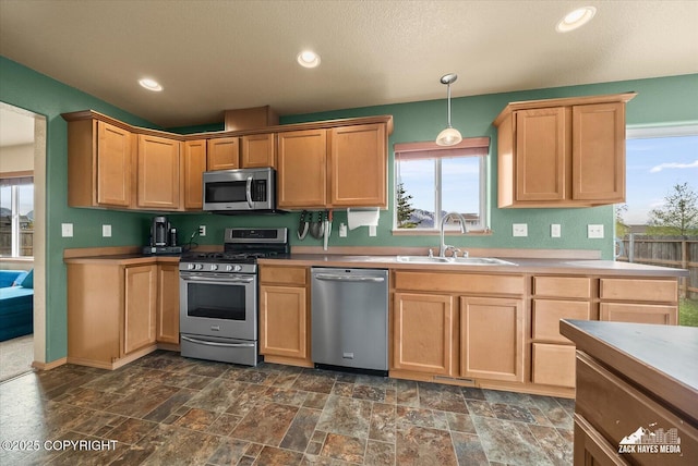 241 N Pasture Pl, Palmer, AK 99645 - kitchen with appliances with stainless steel finishes, a sink, light brown cabinetry, pendant lighting, and dark stone finish floors
