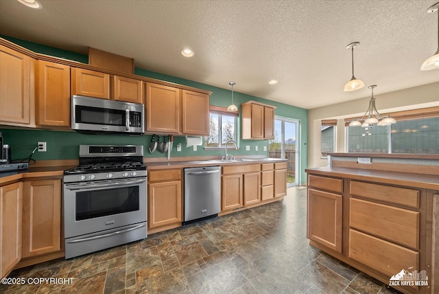 241 N Pasture Pl, Palmer, AK 99645 - kitchen featuring appliances with stainless steel finishes, a sink, a textured ceiling, pendant lighting, and recessed lighting