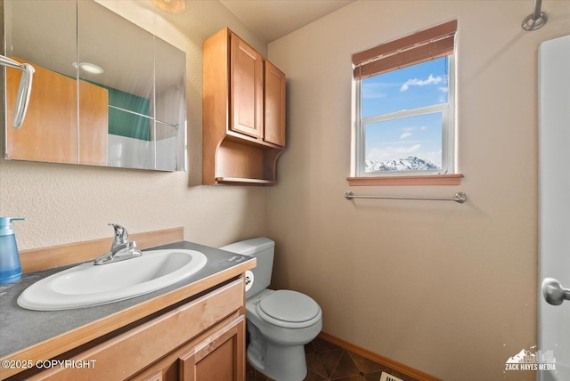 241 N Pasture Pl, Palmer, AK 99645 - bathroom with toilet, vanity, and baseboards