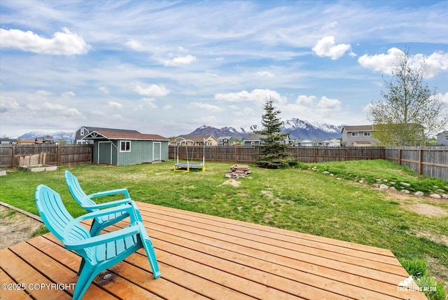 241 N Pasture Pl, Palmer, AK 99645 - wooden deck featuring a trampoline, a shed, an outbuilding, and a mountain view