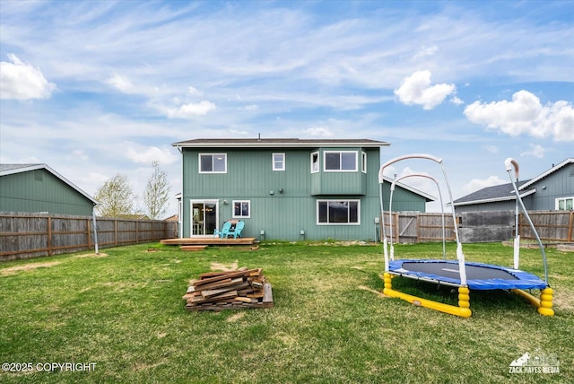 241 N Pasture Pl, Palmer, AK 99645 - back of property with a trampoline and a deck