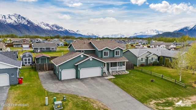 241 N Pasture Pl, Palmer, AK 99645 - traditional-style home with a residential view, a mountain view, driveway, a garage, and covered porch