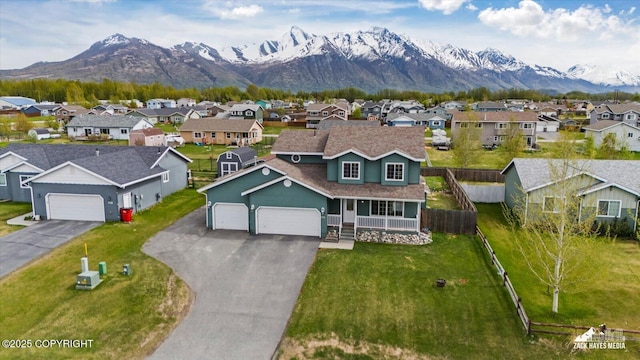 241 N Pasture Pl, Palmer, AK 99645 - view of front facade featuring a residential view, a mountain view, an attached garage, driveway, and covered porch