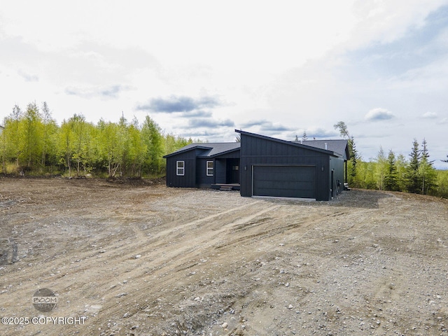 1866 S Rolling Hills St, Wasilla, AK 99623 - view of outdoor structure featuring an attached garage and driveway