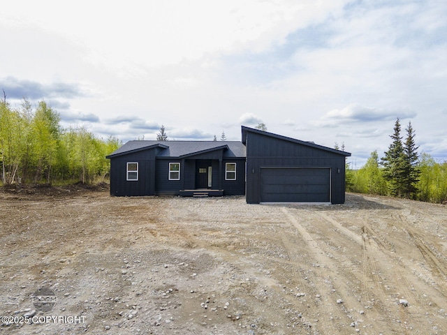 1866 S Rolling Hills St, Wasilla, AK 99623 - view of front of home with an attached garage and dirt driveway