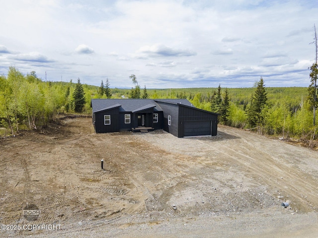 1866 S Rolling Hills St, Wasilla, AK 99623 - view of outdoor structure with an attached garage and dirt driveway
